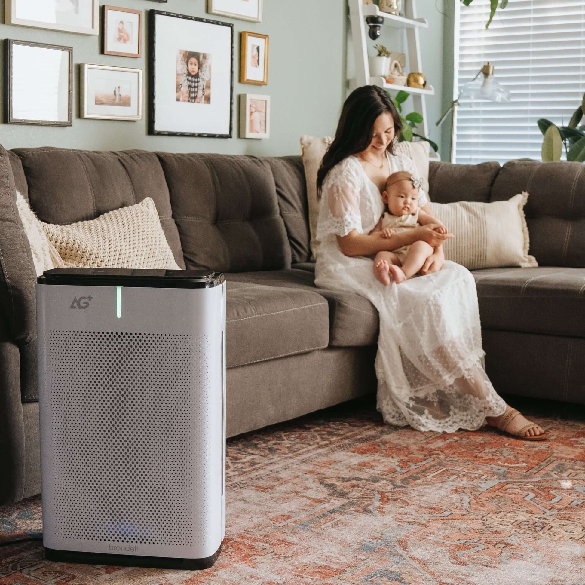 Brondell Pro Sanitizing Air Purifier with AG+ Technology for Purification of SARS-CoV-2, Virus, Bacteria and Allergens - front view in a room by a couch