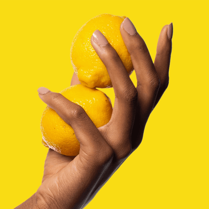Poo~Pourri Original Citrus Toilet Spray 2oz Boxed - hand holding lemons