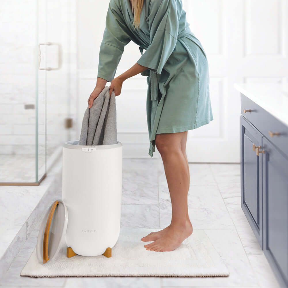 Luxury Towel Warmer - front view in a bathroom with woman pulling out a towel