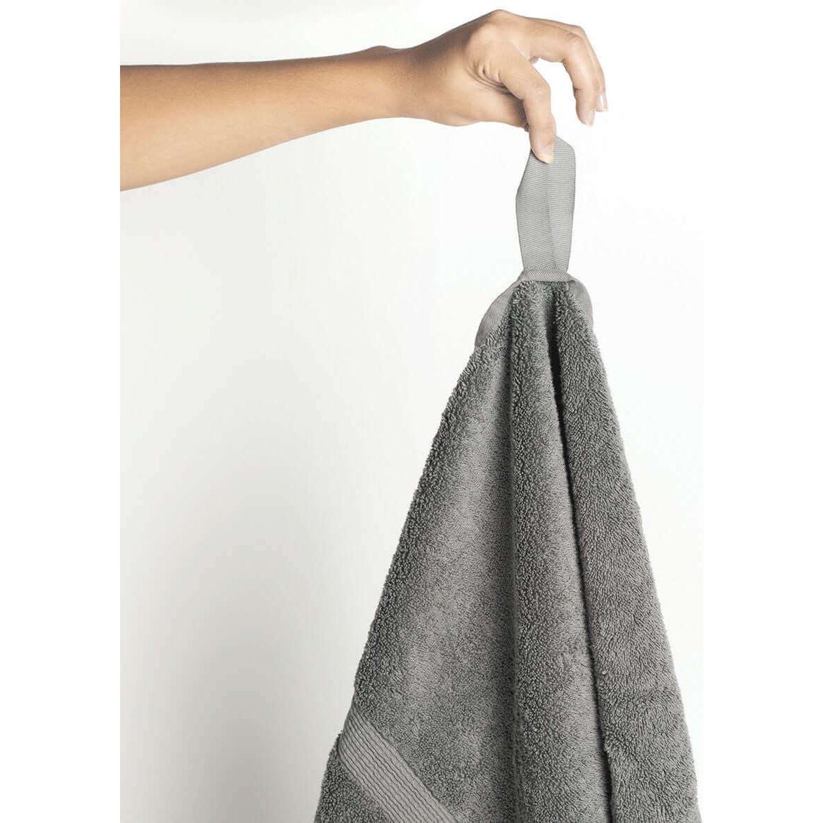 Nebia Hand Towel - front view of hand holding towel in color grey