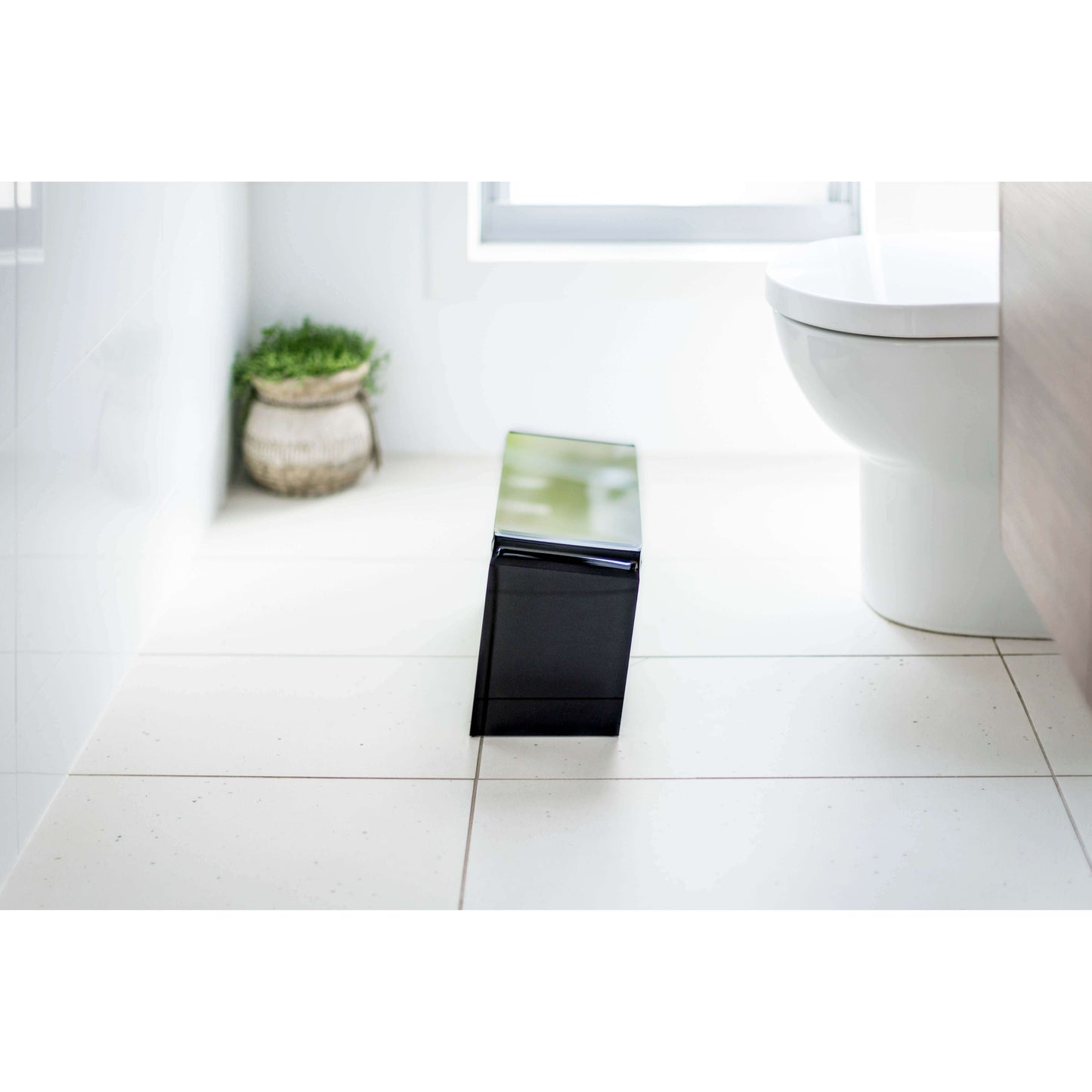 The PROPPR Acer - Black Toilet Foot Stool - side view in a bathroom