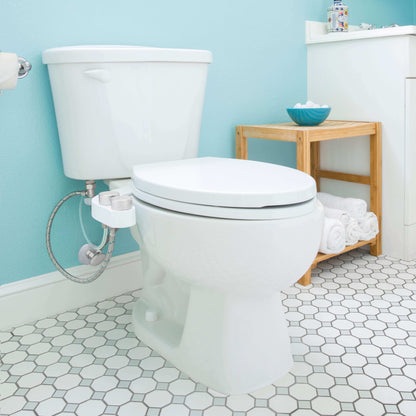 FreshSpa Comfort+ Bidet Attachment, Dual Temperature, Dual Nozzles - side angled view attached to toilet in a bathroom
