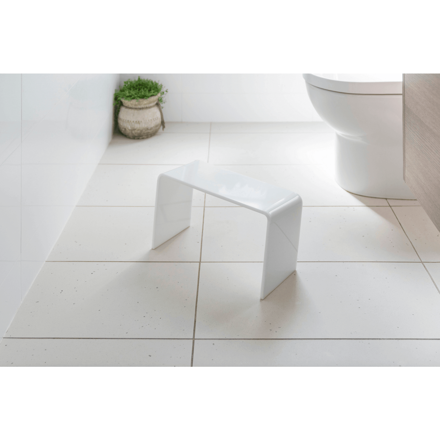 The PROPPR Acer - White Toilet Foot Stool - side angled view in a bathroom