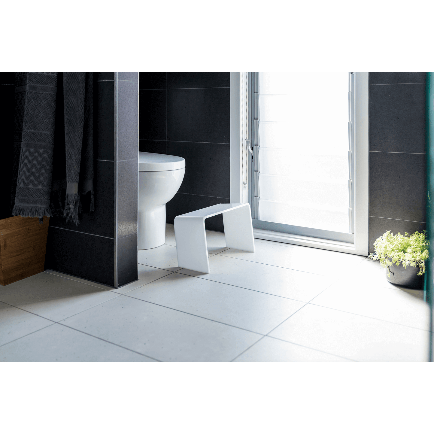 The PROPPR Acer - White Toilet Foot Stool - side angled view in a bathroom