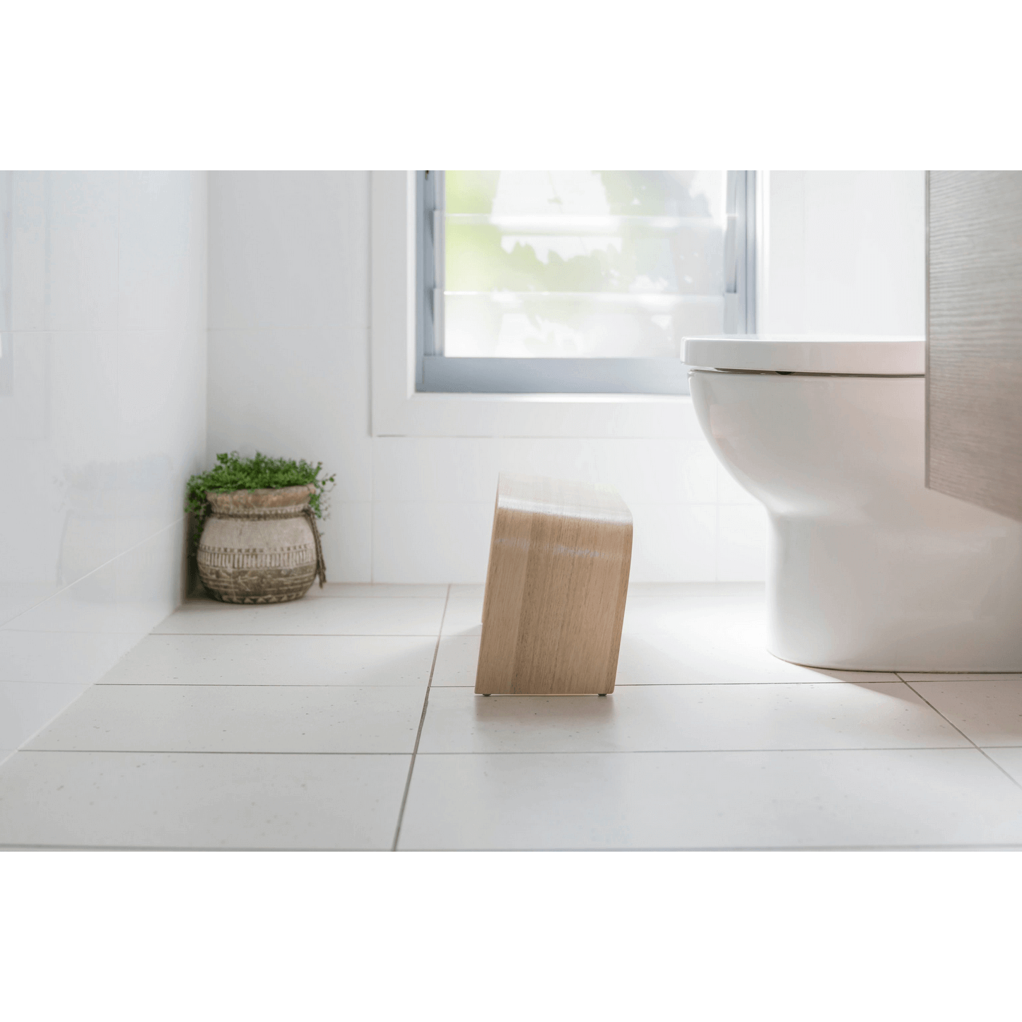 The PROPPR Timber - Whitewash Toilet Foot Stool - side view in a bathroom