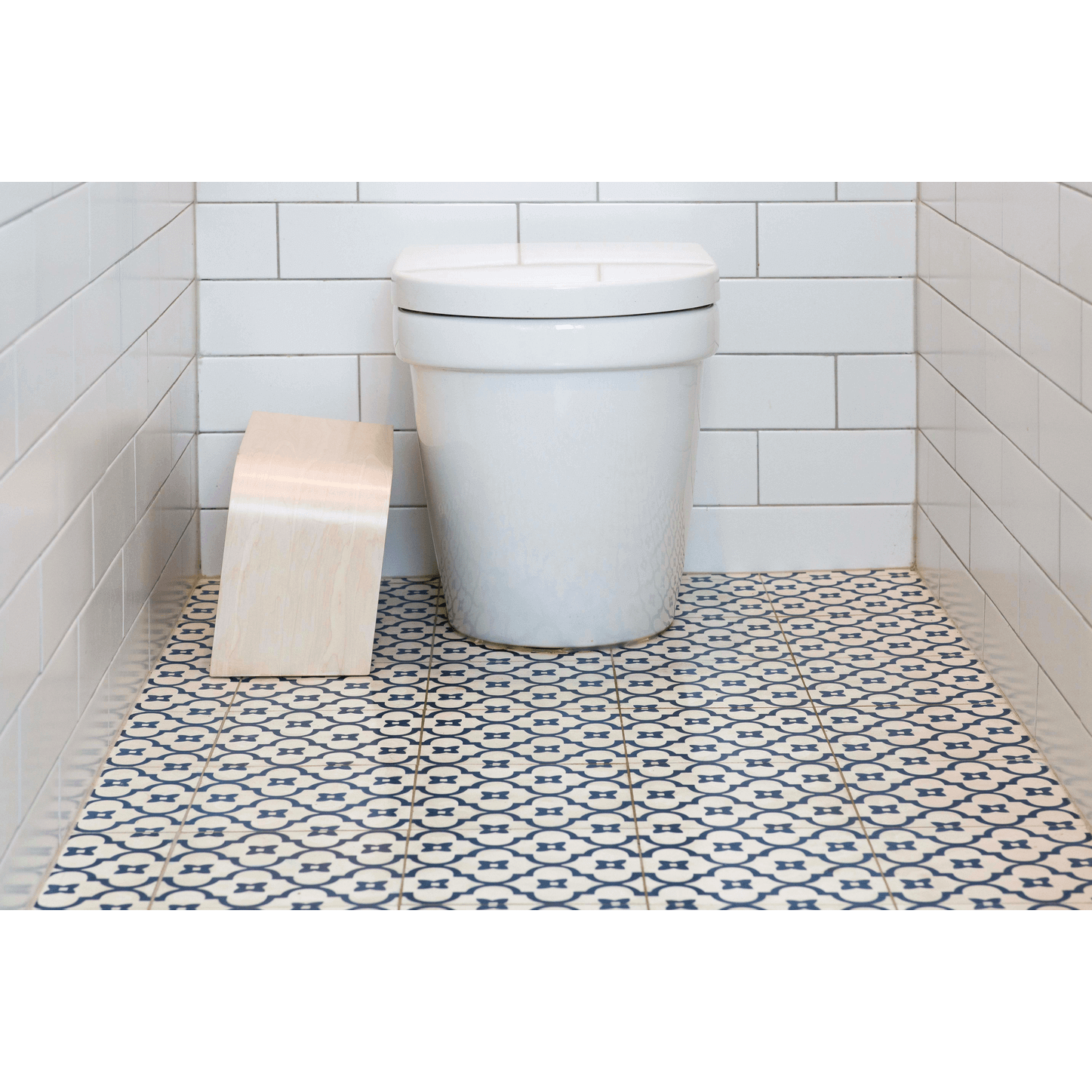 The PROPPR Timber - Whitewash Toilet Foot Stool - side view in a bathroom beside a toilet
