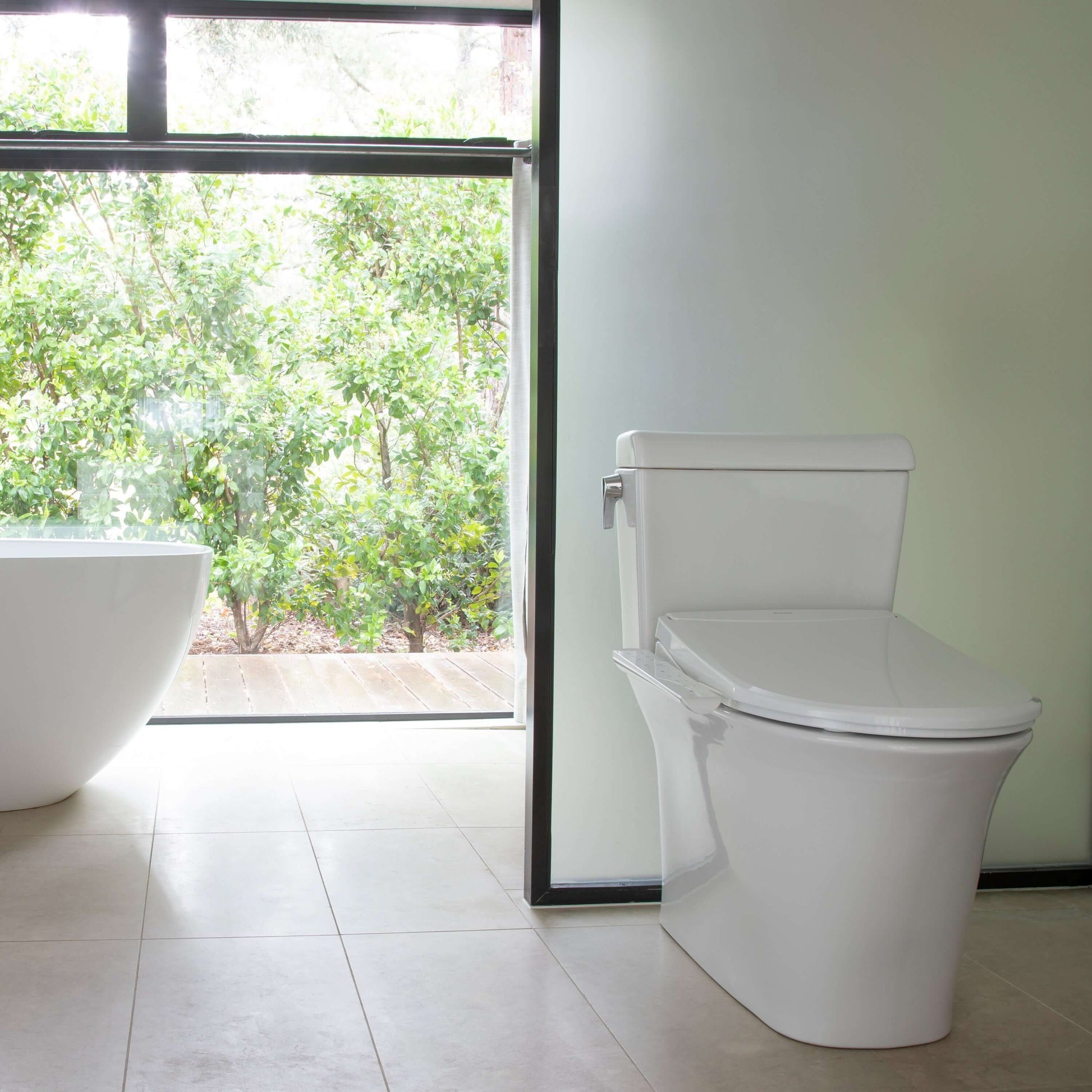 Swash Thinline T22 Bidet Seat - front view attached to a toilet in a bathroom